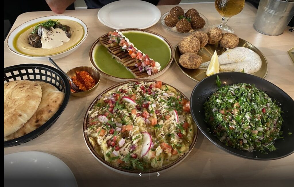 kosher restaurant in madrid with table full of food 